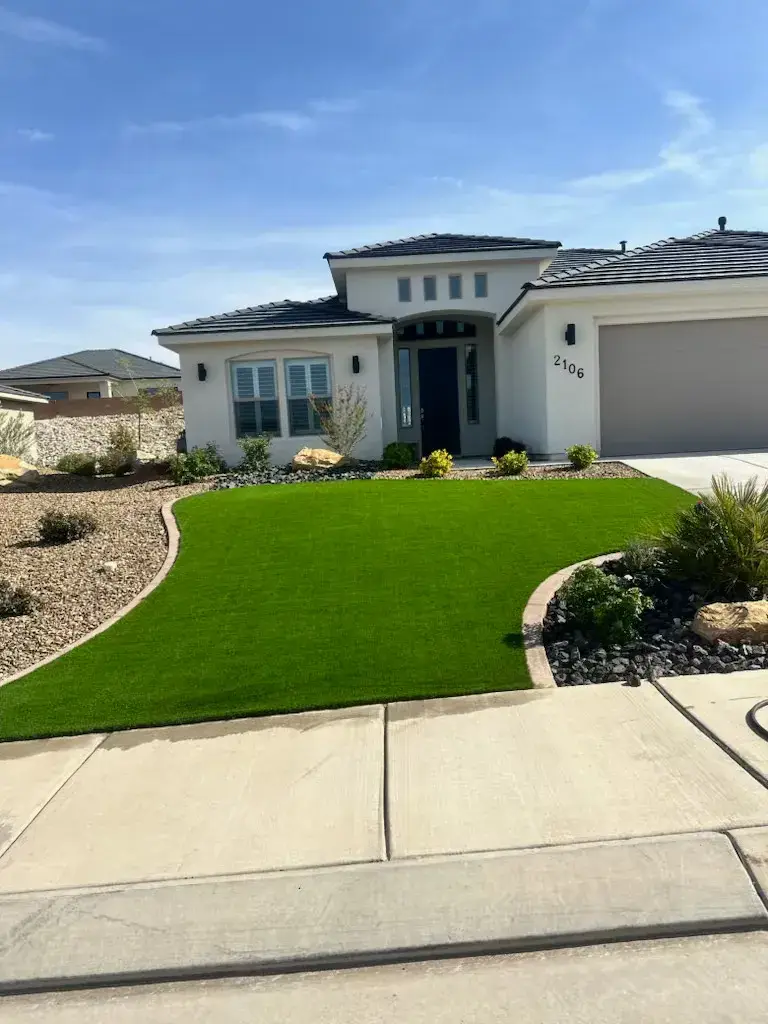 New-construction home with an artificial turf front yard